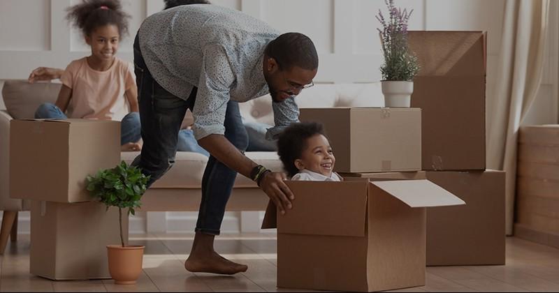 Man pushing kid in box